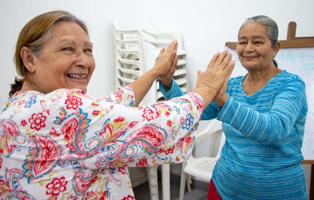 Imagen de dos señoras tomadas de la mano