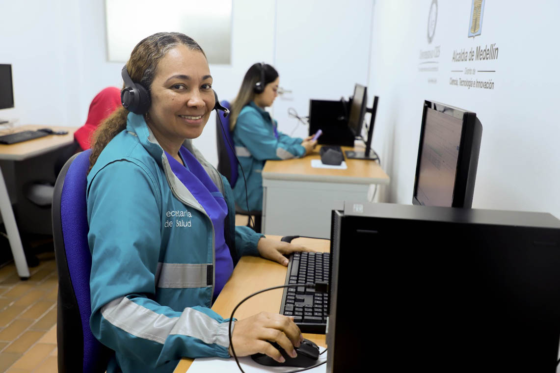 Imagen de funcionaria sonriente en computador