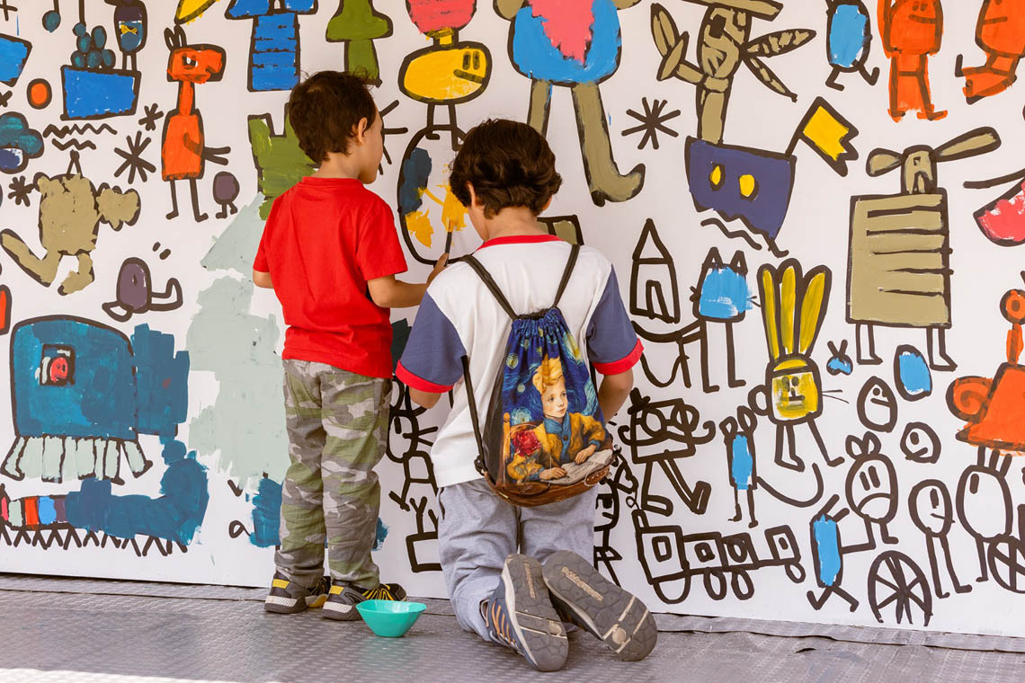 Imagen de dos niños pintando un mural